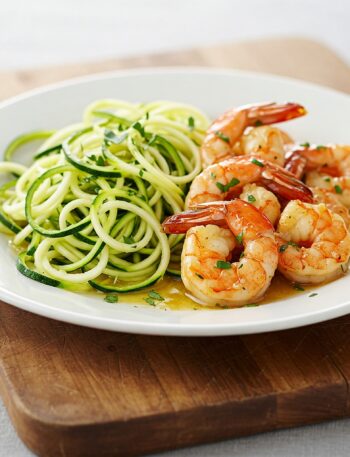 Paleo garlic butter prawns on spiralized zucchini noodles, garnished with fresh parsley