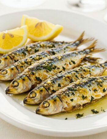 Crispy Mediterranean sardines garnished with fresh herbs